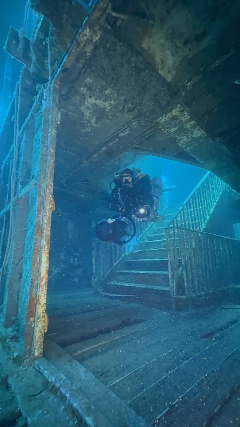 A diver descending the staircase inside the MV Karwela wreck, Gozo