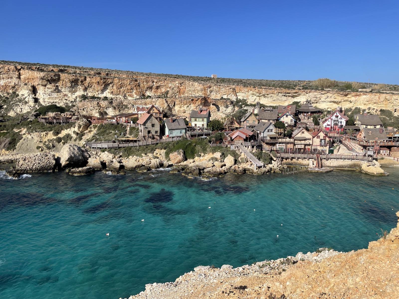 Turquoise water and clear blue skies at Anchor Bay, Malta
