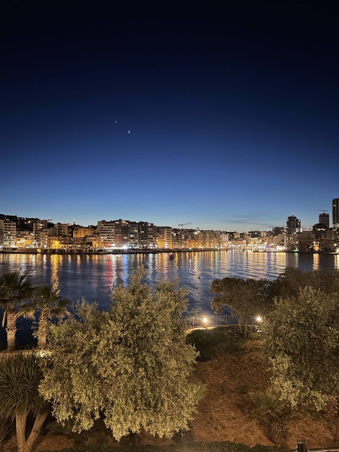 The Sliema waterfront in Malta lit up at dusk