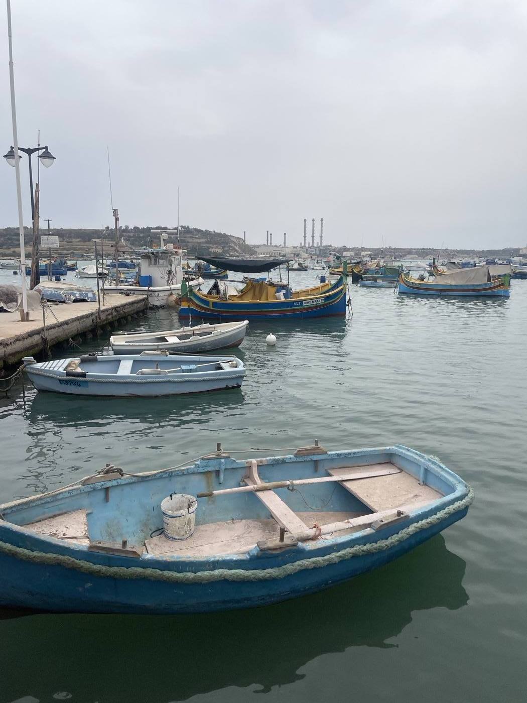 Traditional painted luzzu fishing boats in Marsaxlokk harbour, Malta